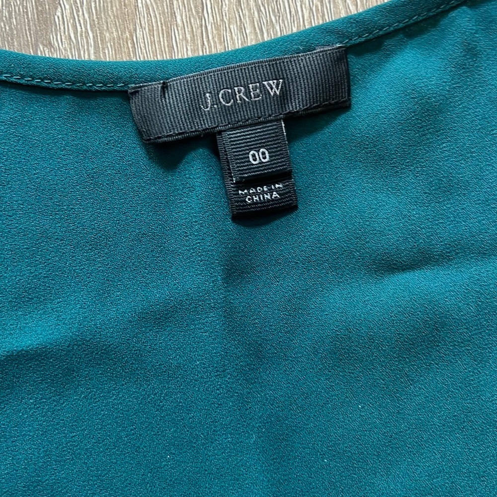 Sleeveless green JCrew silk shirt.